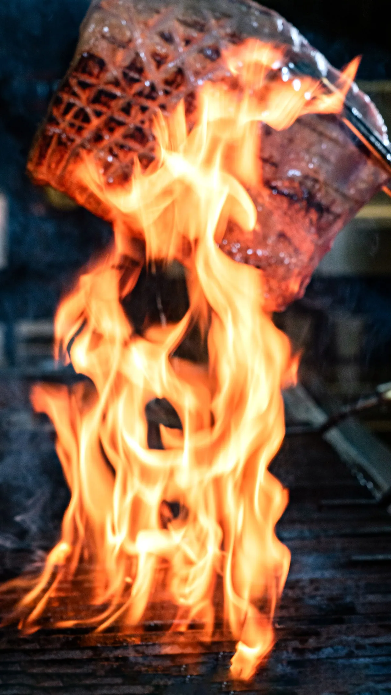 Steak ablaze with flames on the teppanyaki grill