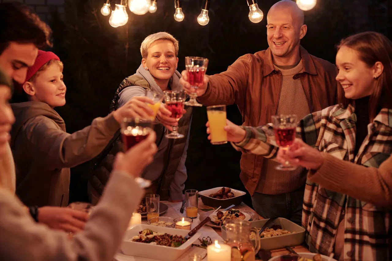 Guests raising a toast at an outdoor dinner